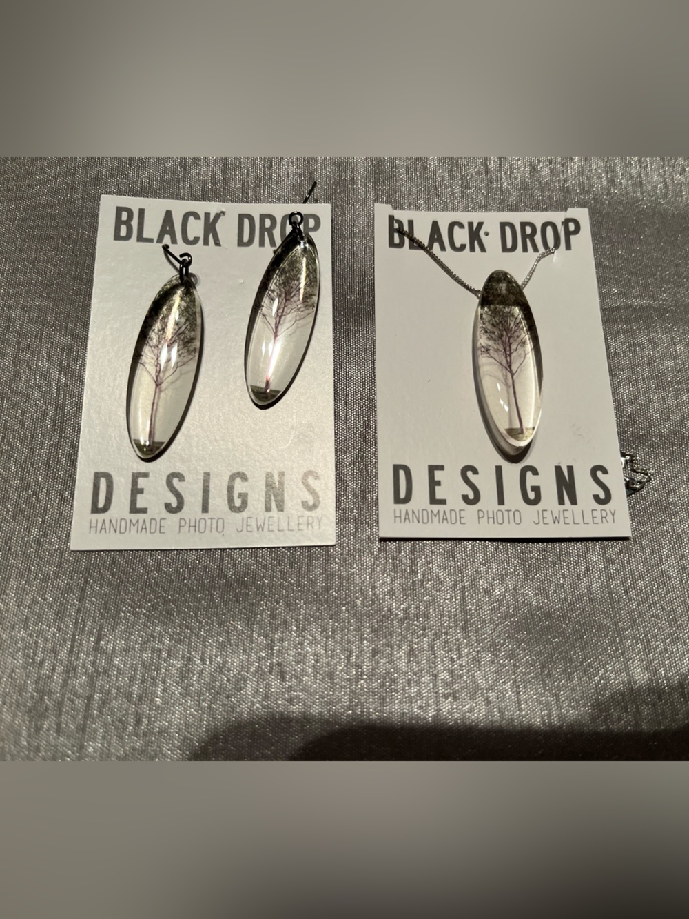 Black Drop Designs Clear Oval Earrings with Subtle Black Tree Detail